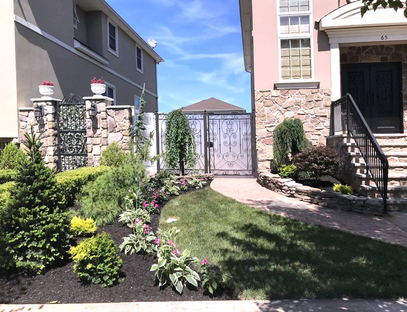 Stucco and stone house with landscaped front beds and steps
